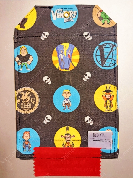 An image depicting a DragonCon badge holder adorned with dragon scale textures amidst a backdrop of nerdy sci-fi fabrics.