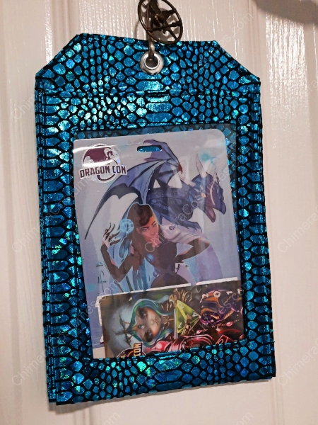An image of a badge holder adorned with nerdy sci-fi fabrics, highlighted by the striking appearance of dragon scales.